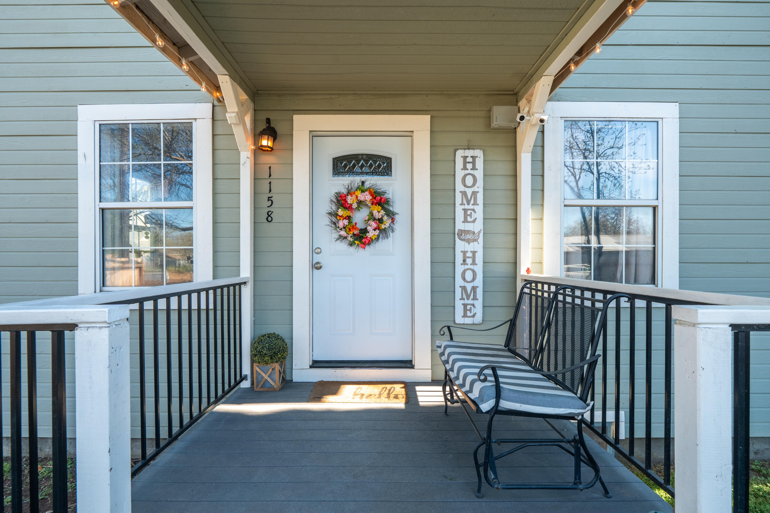 1158 Madison Street Red Bluff, CA 96080 - Photo 2 of 36 a view of a porch with wooden floor and outdoor seating