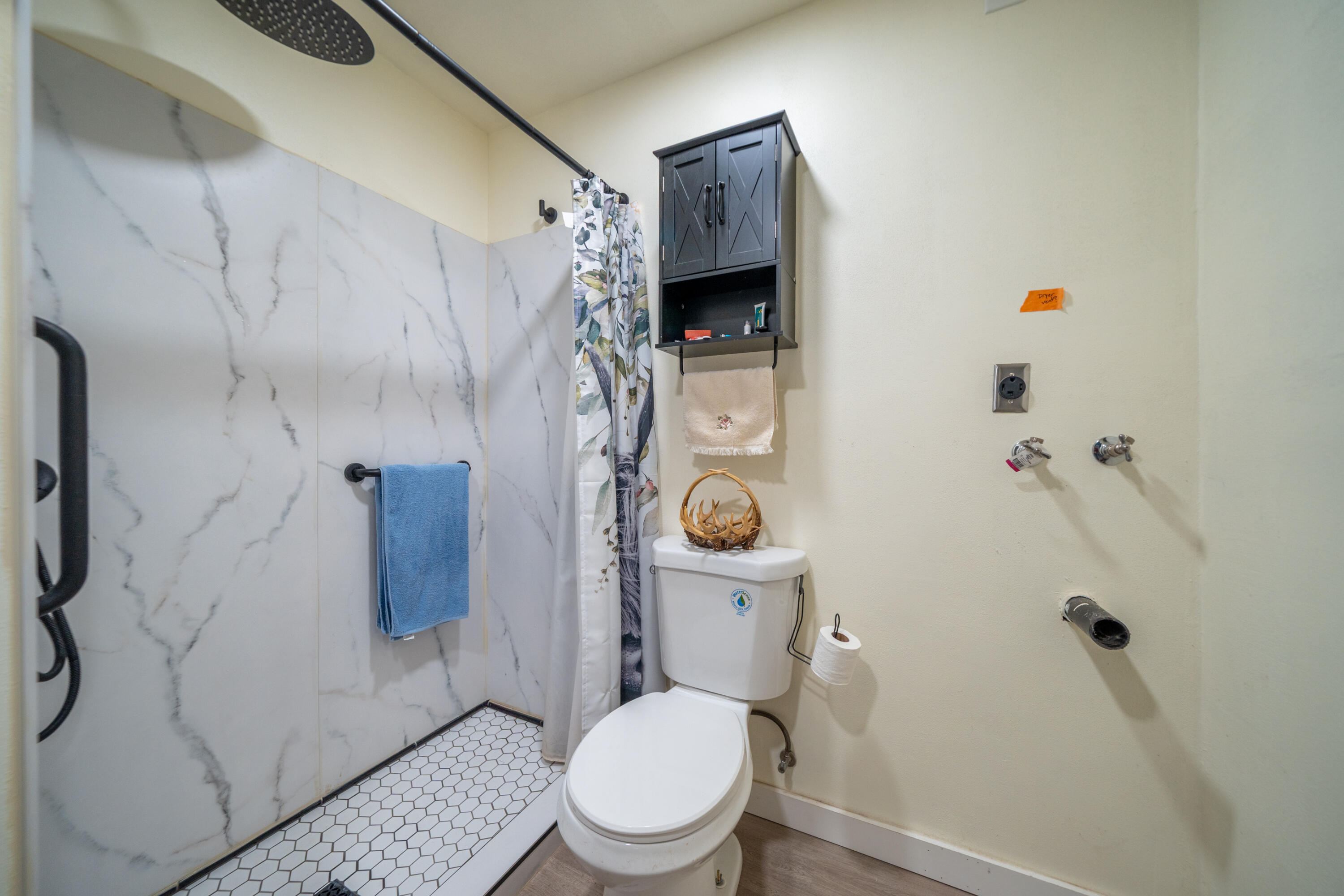 1158 Madison Street Red Bluff, CA 96080 - Photo 25 of 36 a white toilet sitting next to a bathroom sink