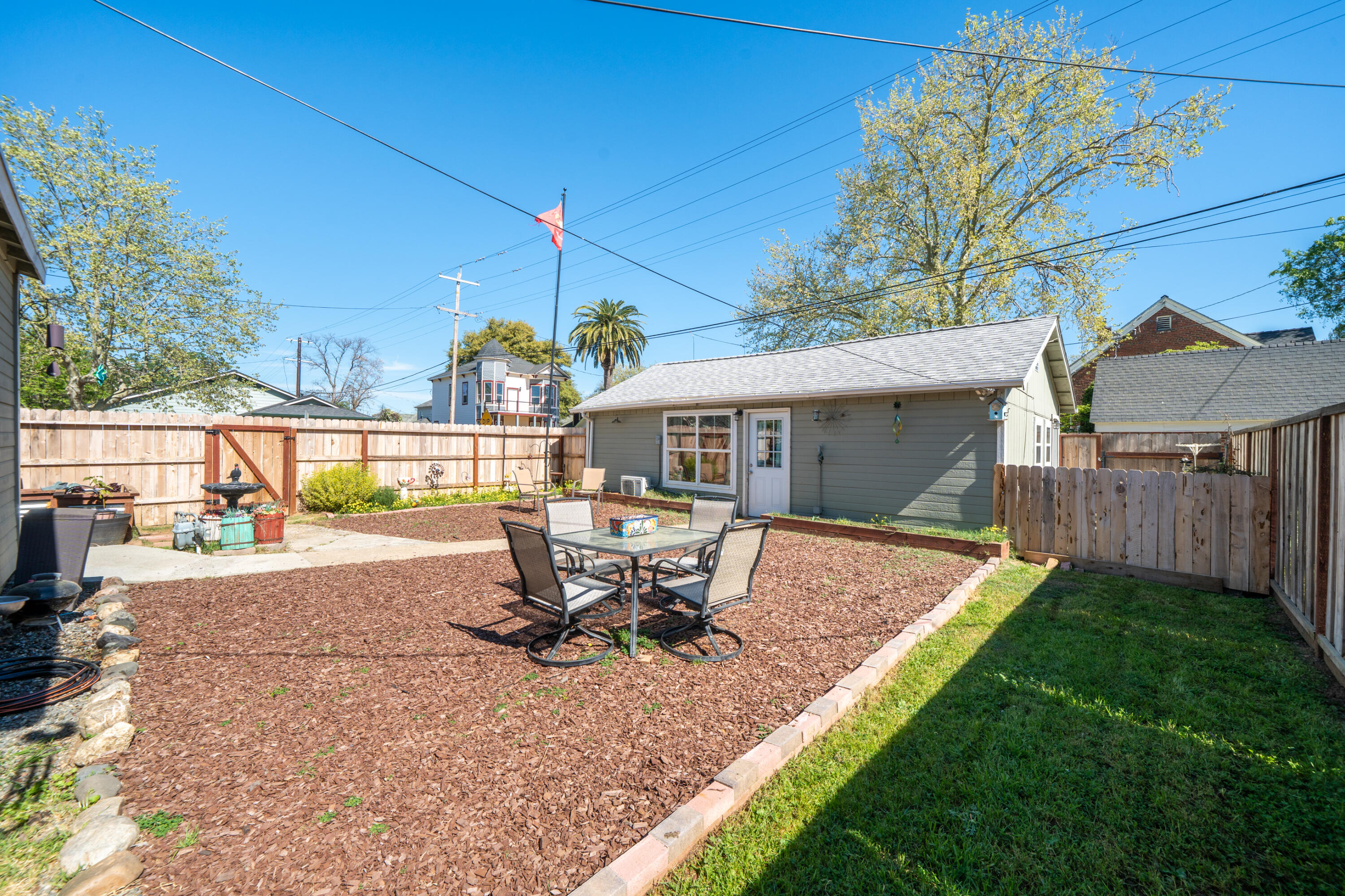 1158 Madison Street Red Bluff, CA 96080 - Photo 35 of 36 a view of a house with backyard sitting area and garden