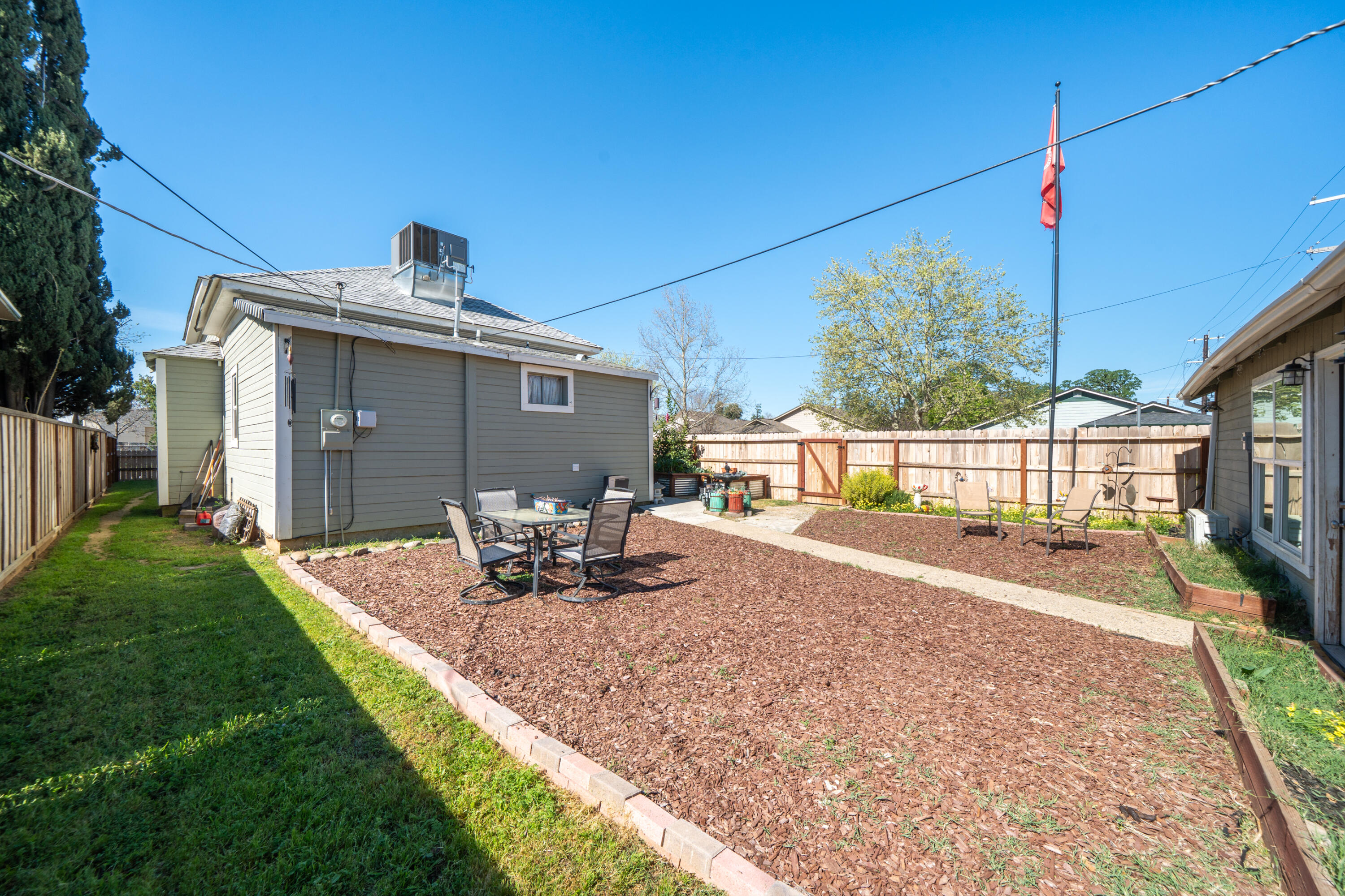 1158 Madison Street Red Bluff, CA 96080 - Photo 36 of 36 a view of a house with backyard sitting area and garden