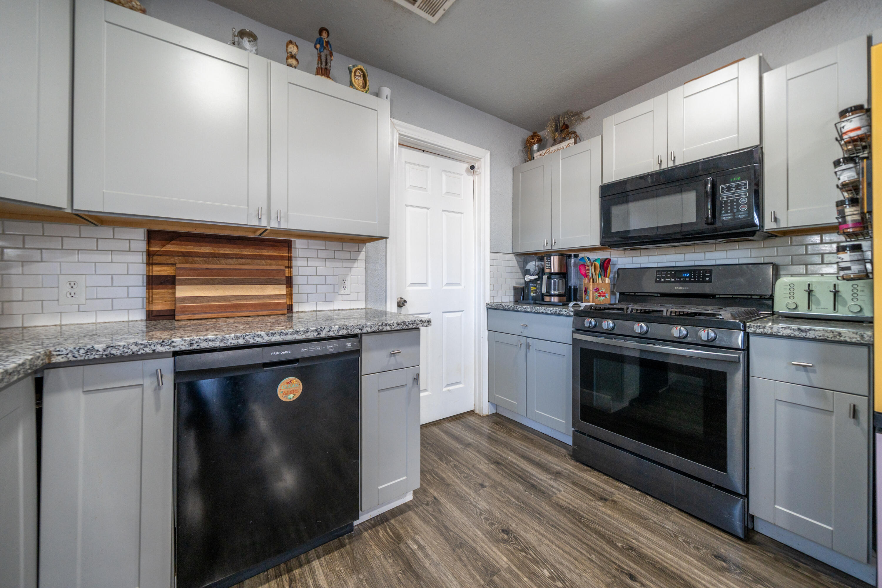 1158 Madison Street Red Bluff, CA 96080 - Photo 5 of 36 a kitchen with stainless steel appliances granite countertop a stove a sink and a microwave