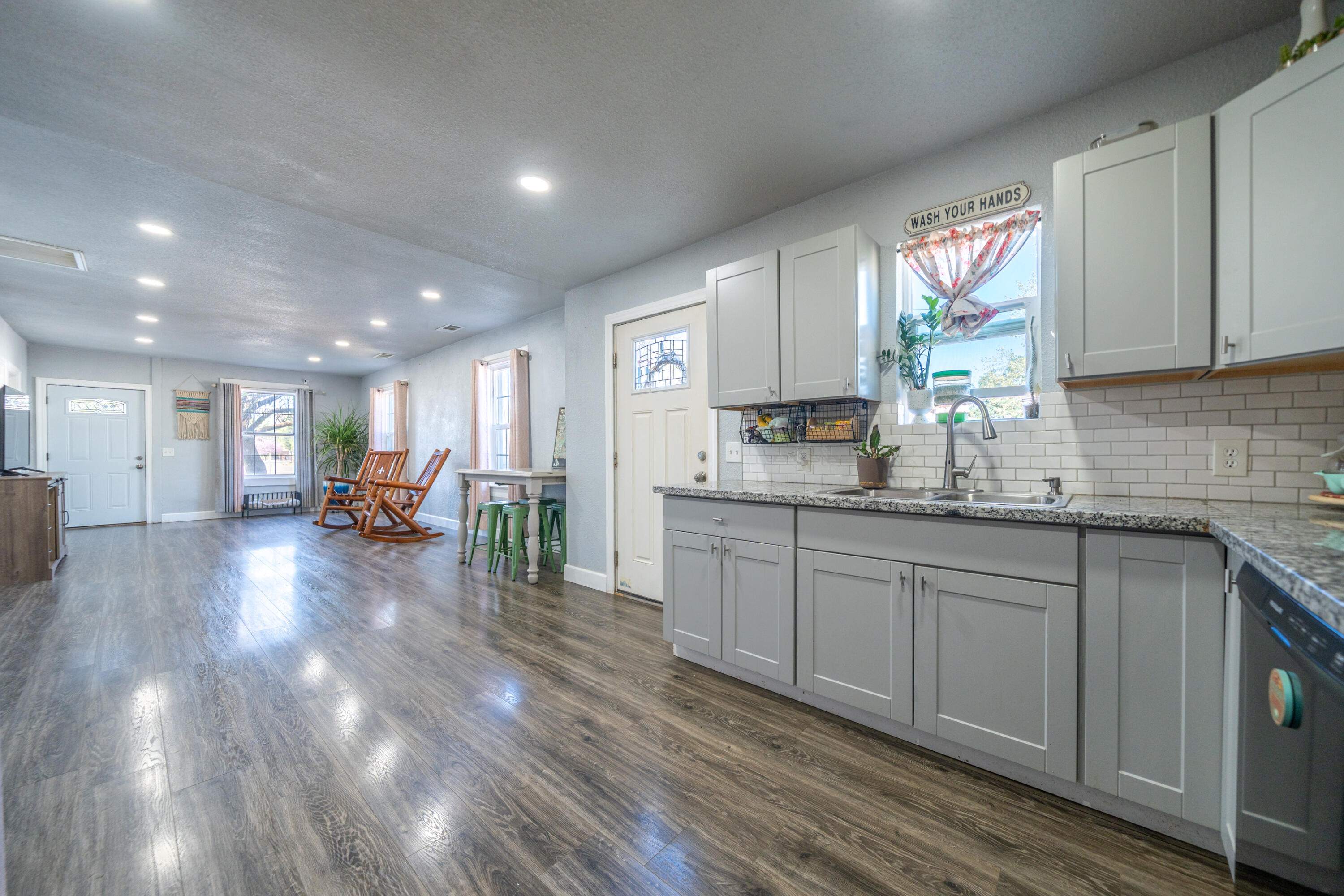 1158 Madison Street Red Bluff, CA 96080 - Photo 6 of 36 a kitchen with sink cabinets and wooden floor