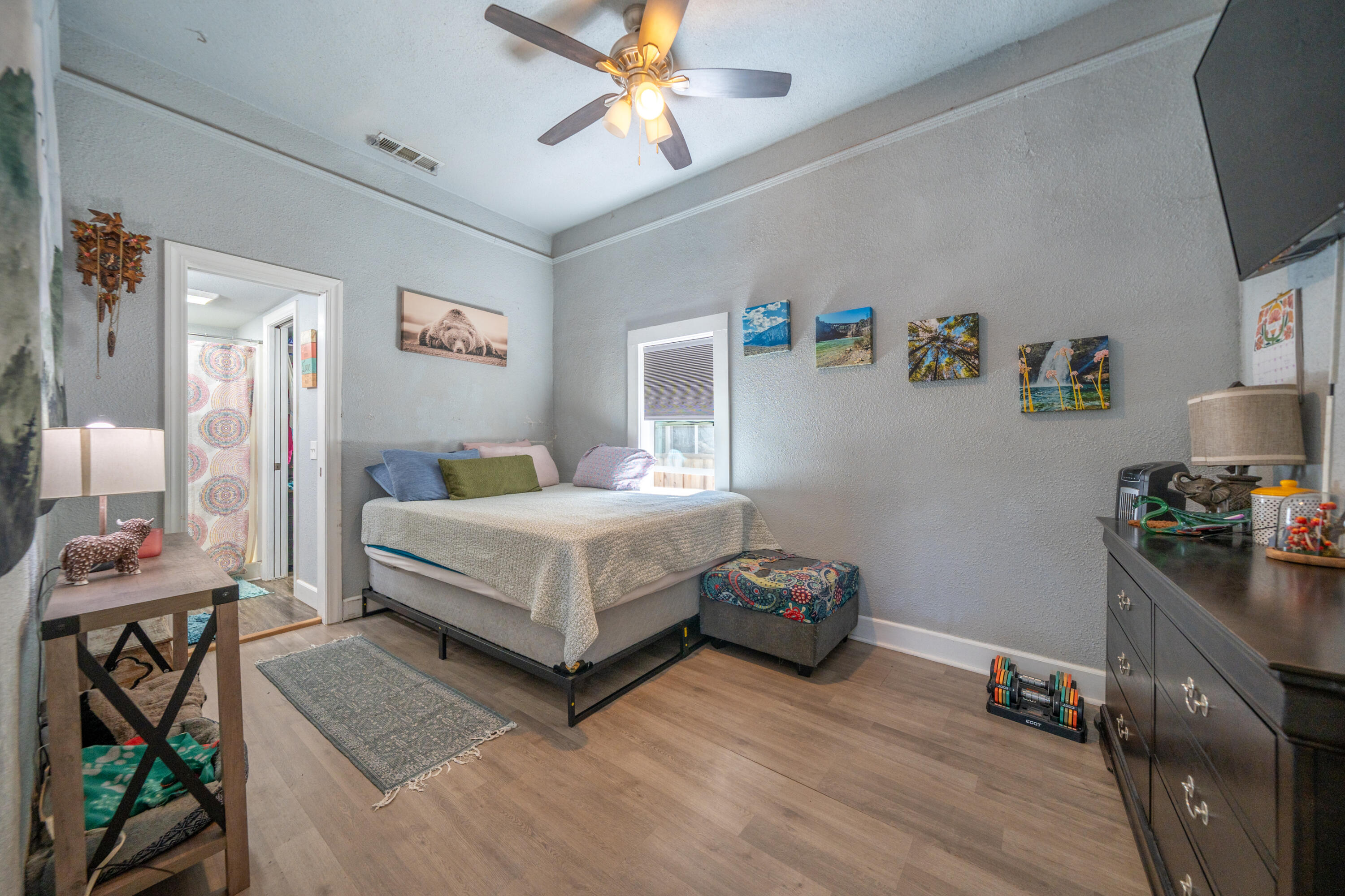 1158 Madison Street Red Bluff, CA 96080 - Photo 7 of 36 a bedroom with a bed and a flat tv screen on the dresser
