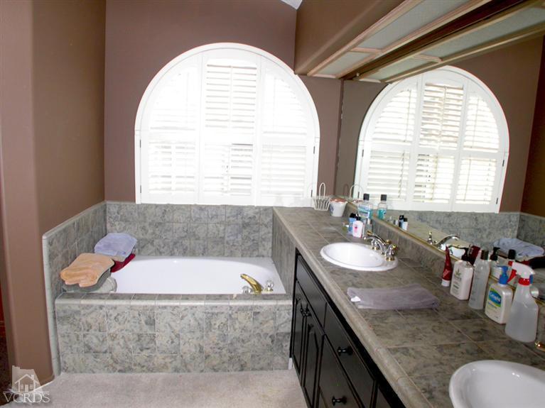 321 Fresh Meadows Road Simi Valley, CA 93065 - Photo 14 of 23 a bathroom with a granite countertop sink and a mirror