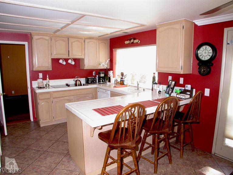 321 Fresh Meadows Road Simi Valley, CA 93065 - Photo 7 of 23 a dining hall with granite countertop a dining table chairs and a refrigerator