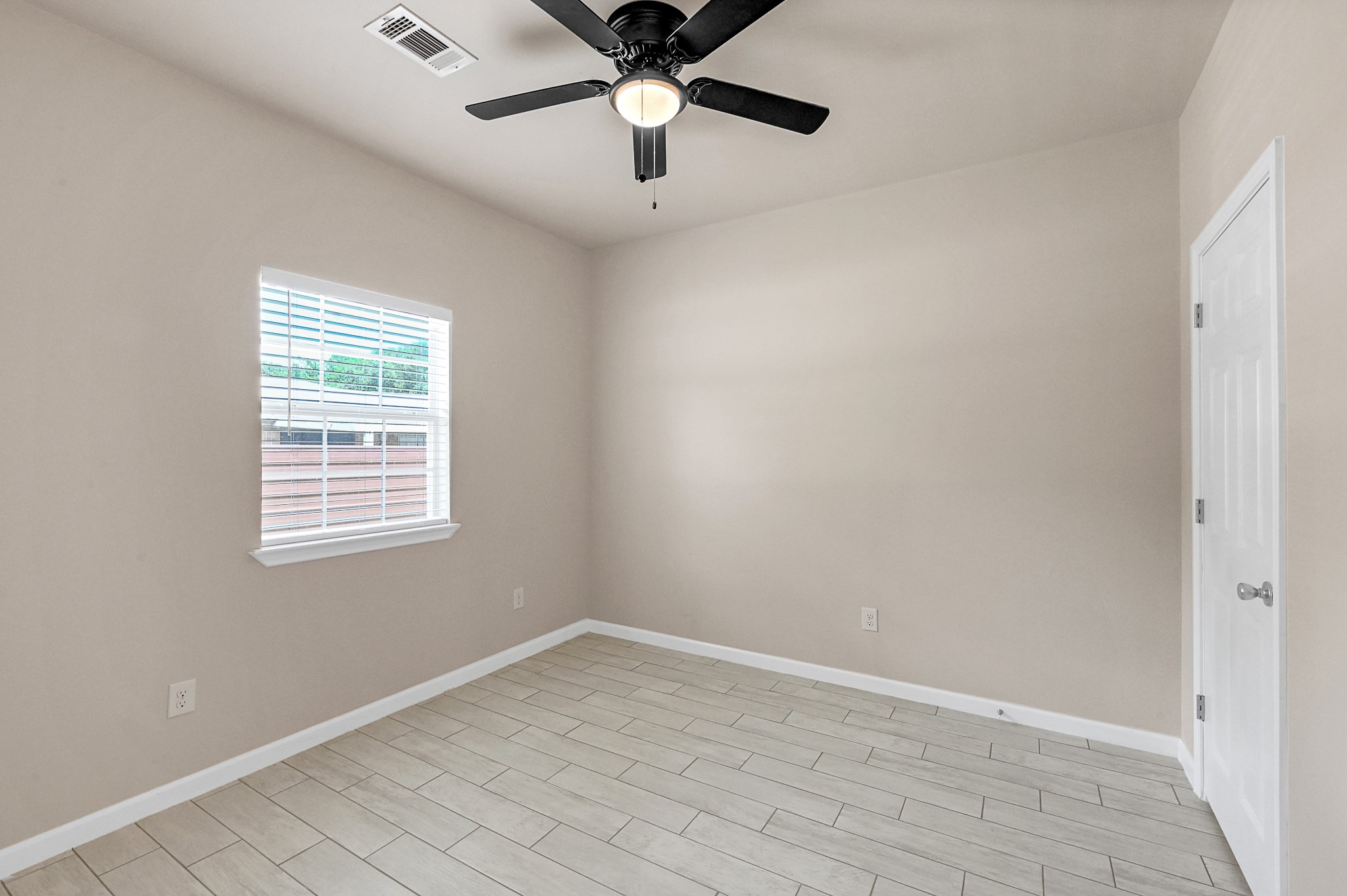 20603 Marilyn Lane, Unit B Spring, TX 77388 - Photo 14 of 18 wooden floor in an empty room with a window