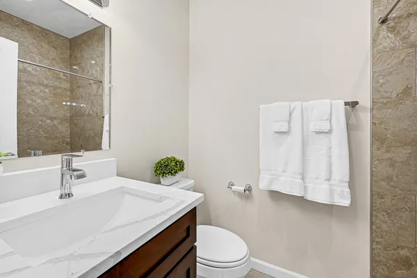 a bathroom with a sink toilet and shower