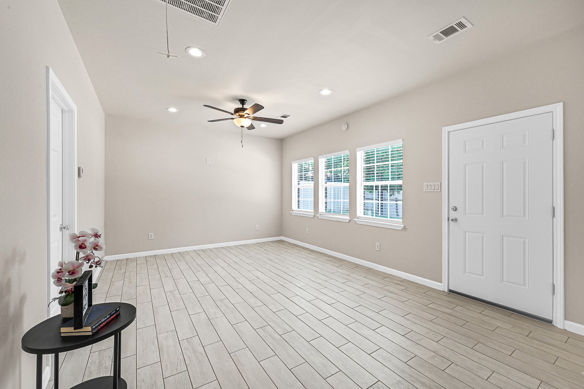 20603 Marilyn Lane, Unit B Spring, TX 77388 - Photo 7 of 18 a view of an empty room with a window and wooden floor