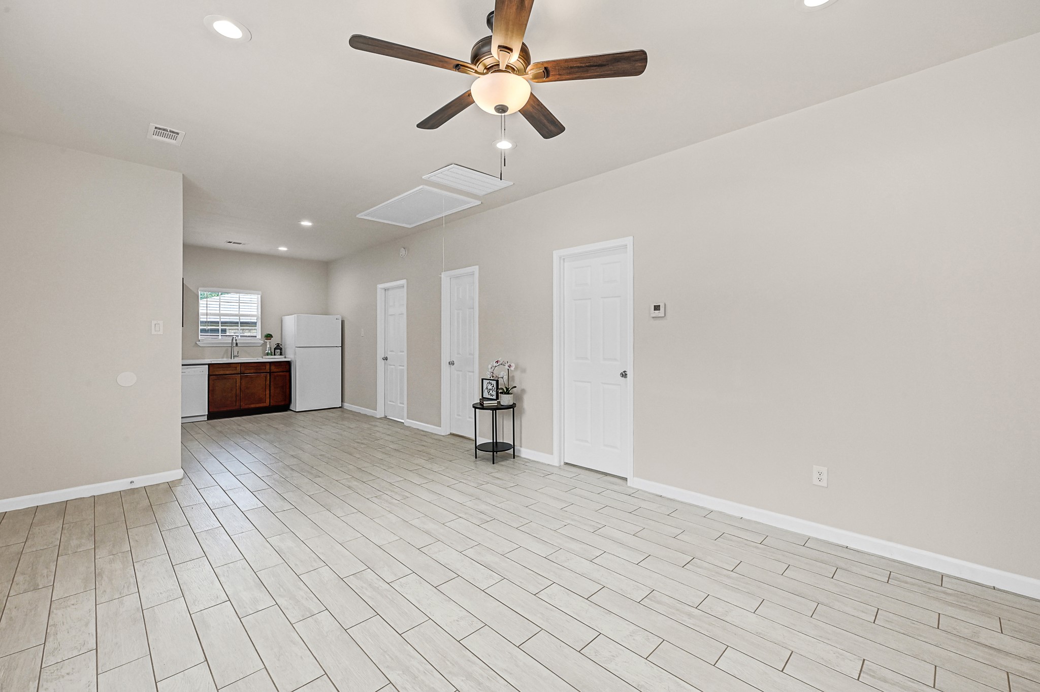 20603 Marilyn Lane, Unit B Spring, TX 77388 - Photo 10 of 18 a view of empty room with wooden floor and ceiling fan