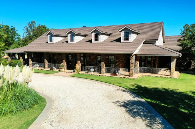 an aerial view of a house with swimming pool and mountain view