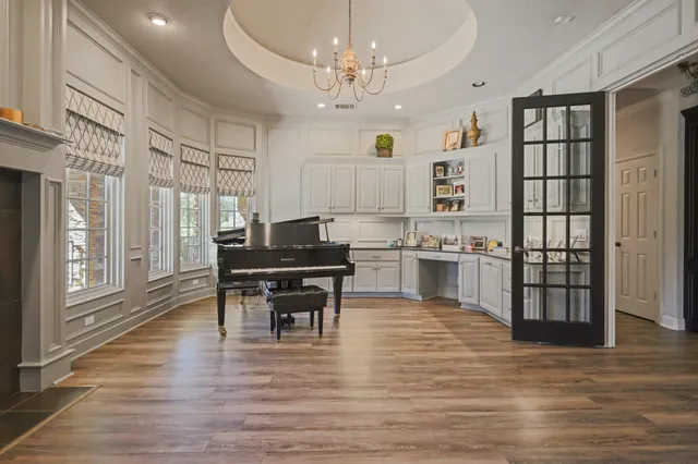 a kitchen with kitchen island granite countertop a large stove a sink and dishwasher with a dining table