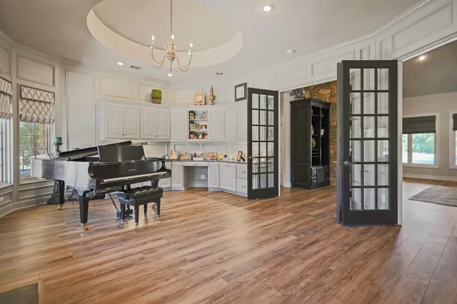 a kitchen with stainless steel appliances kitchen island granite countertop a sink counter space and a window