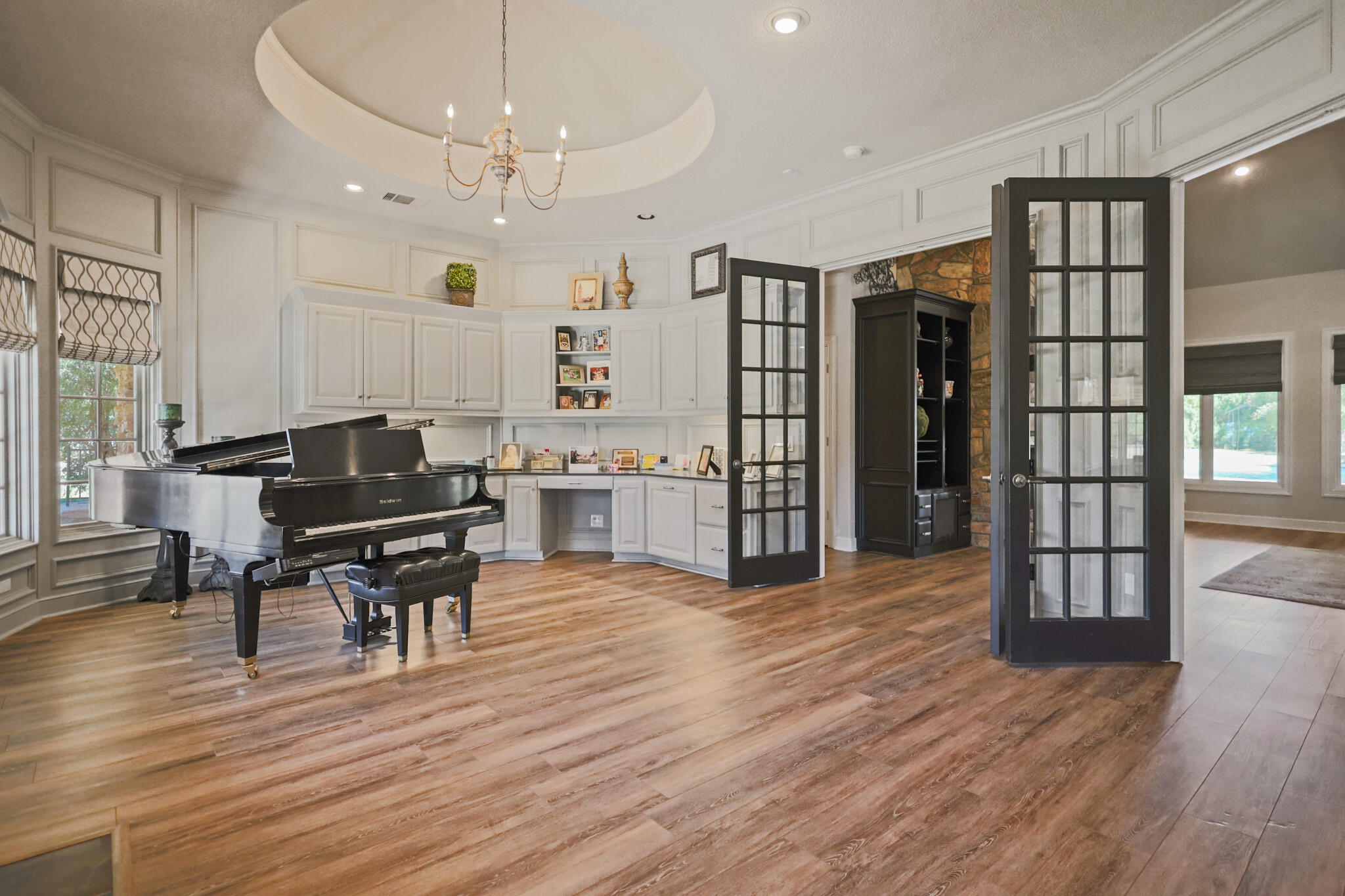 7002 50th Street Lubbock, TX 79407 - Photo 19 of 81 a living room with furniture a piano and a bookshelf