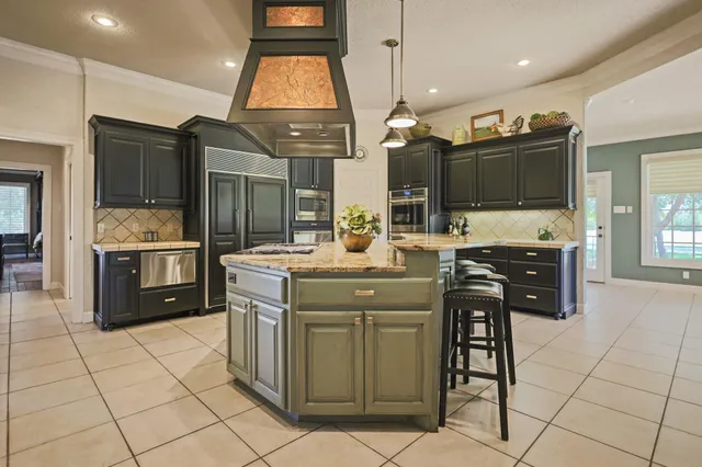 a bathroom with a granite countertop sink and mirror