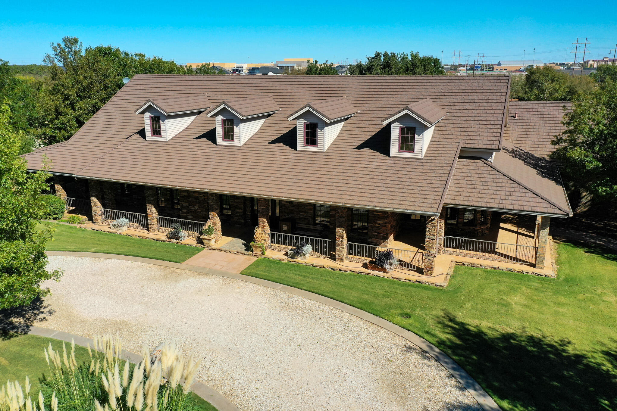 7002 50th Street Lubbock, TX 79407 - Photo 2 of 81 an aerial view of a house with swimming pool and mountain view