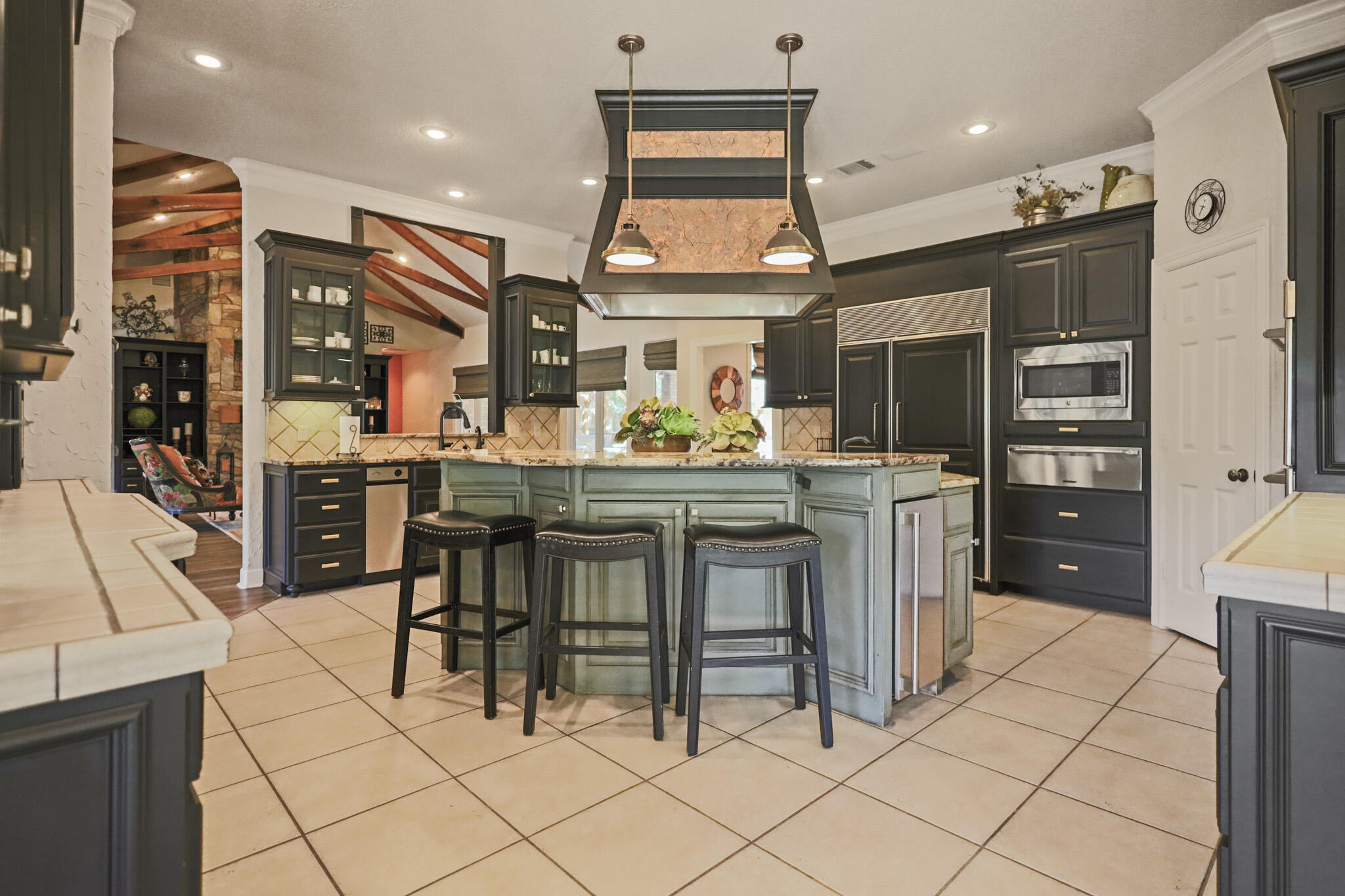 7002 50th Street Lubbock, TX 79407 - Photo 21 of 81 a kitchen with stainless steel appliances kitchen island granite countertop a sink and cabinets