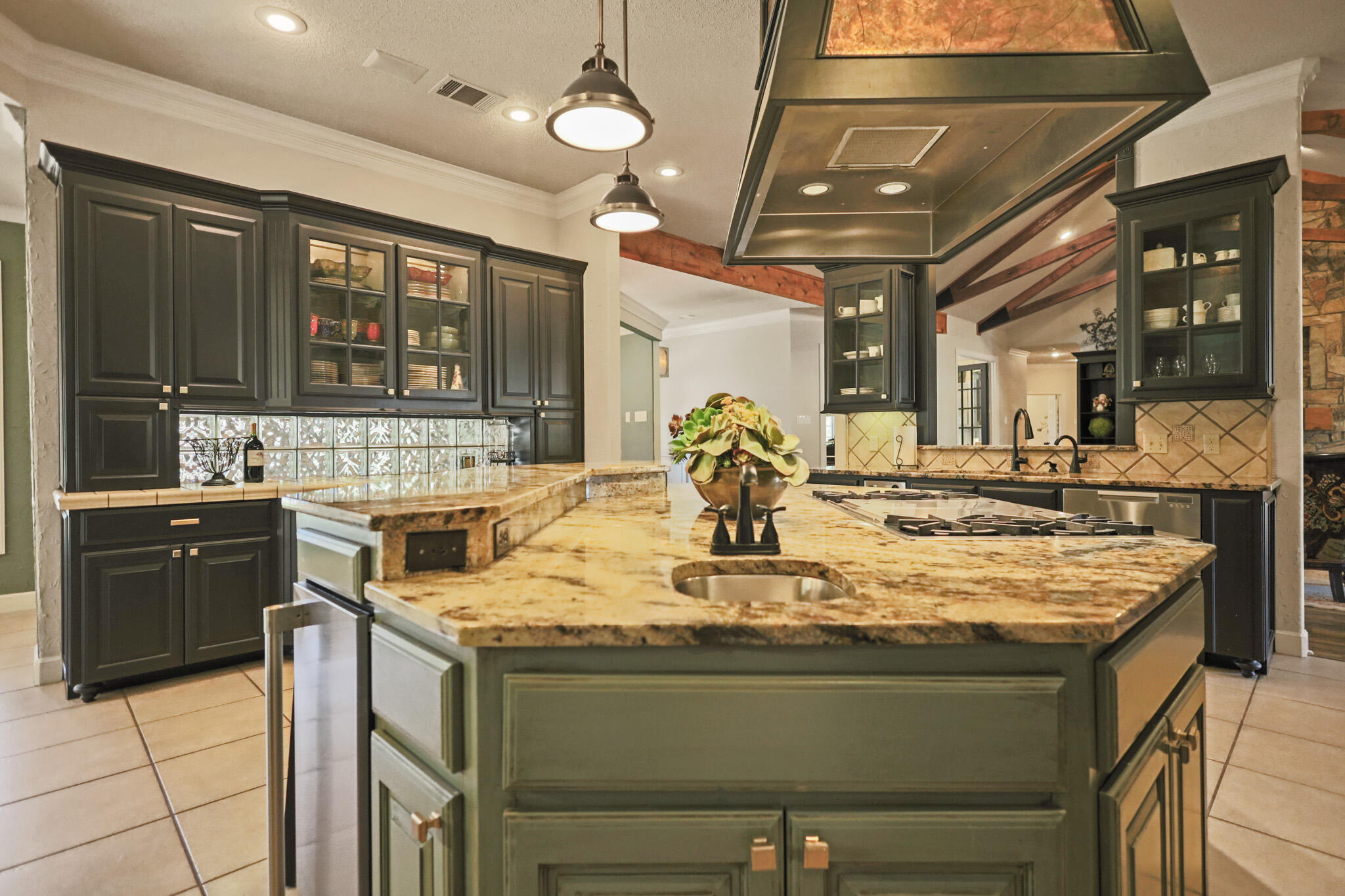 7002 50th Street Lubbock, TX 79407 - Photo 22 of 81 a kitchen with kitchen island granite countertop a large stove a sink and dishwasher with a dining table
