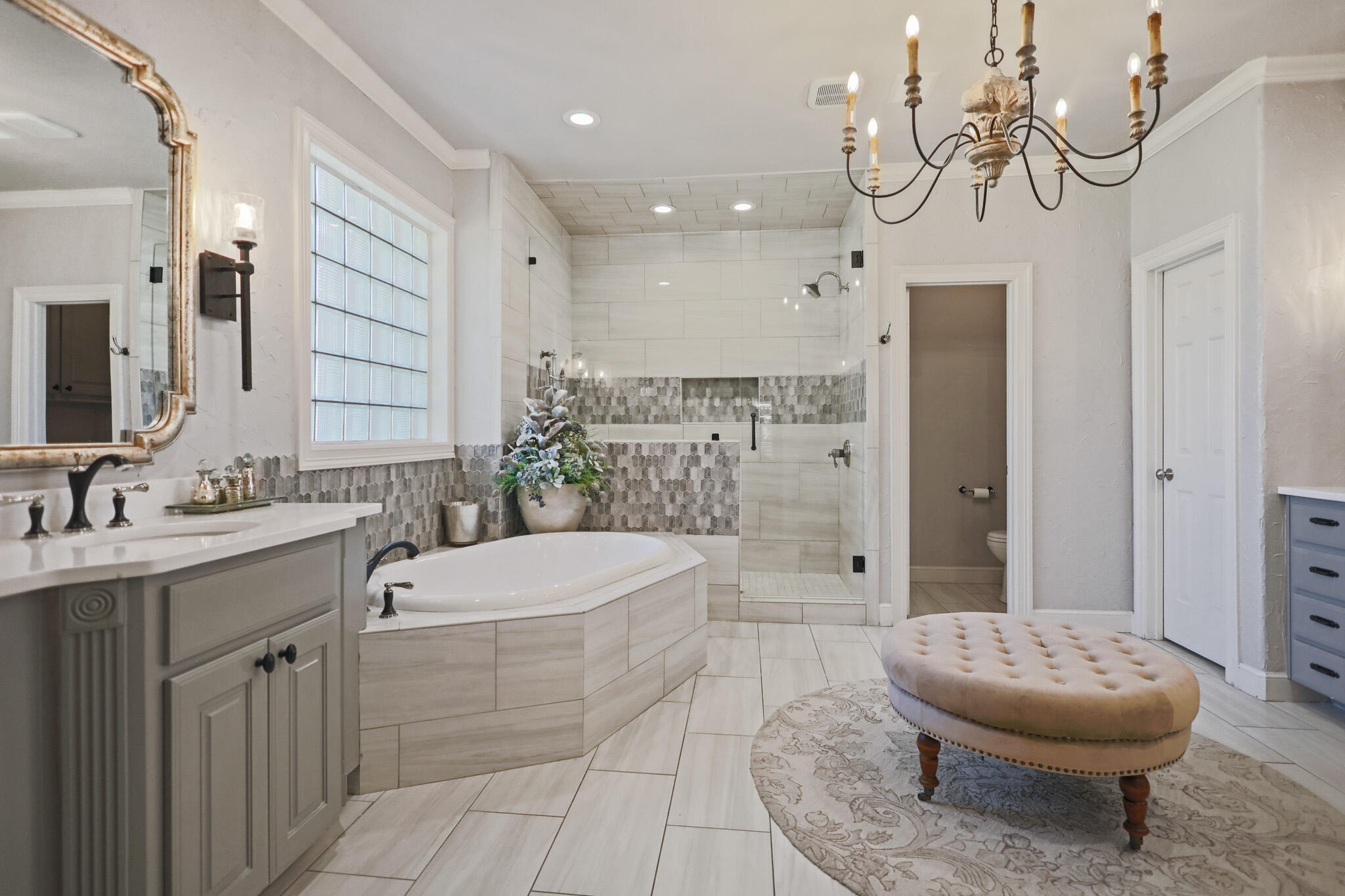 7002 50th Street Lubbock, TX 79407 - Photo 29 of 81 a bathroom with a granite countertop sink a toilet a mirror a vanity and shower