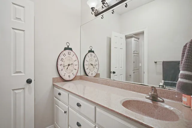 a bathroom with a double vanity sink and a mirror