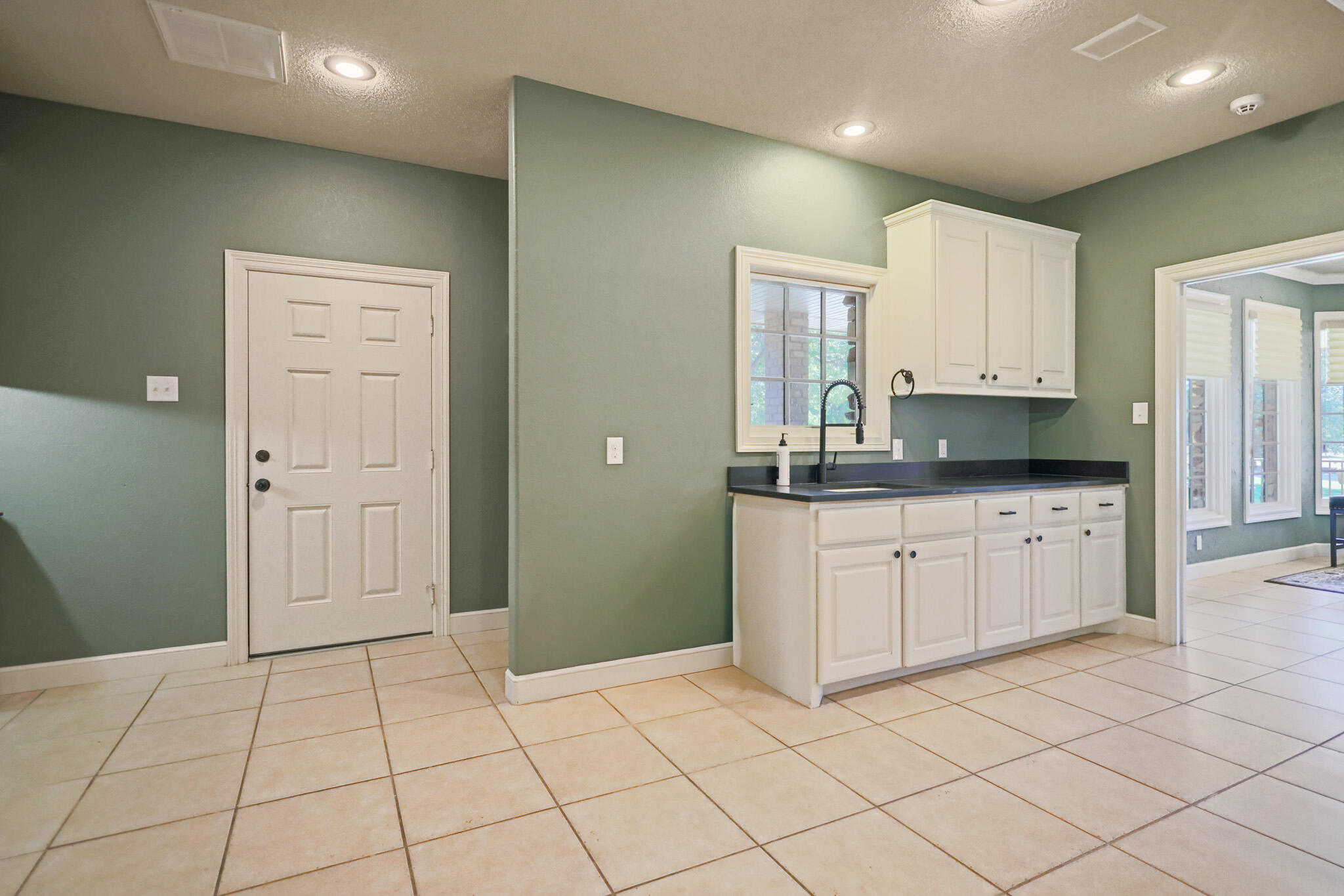 7002 50th Street Lubbock, TX 79407 - Photo 42 of 81 a kitchen with granite countertop white cabinets and stainless steel appliances