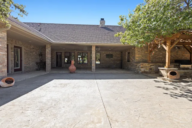 a kitchen with stainless steel appliances granite countertop a sink and cabinets with wooden floor