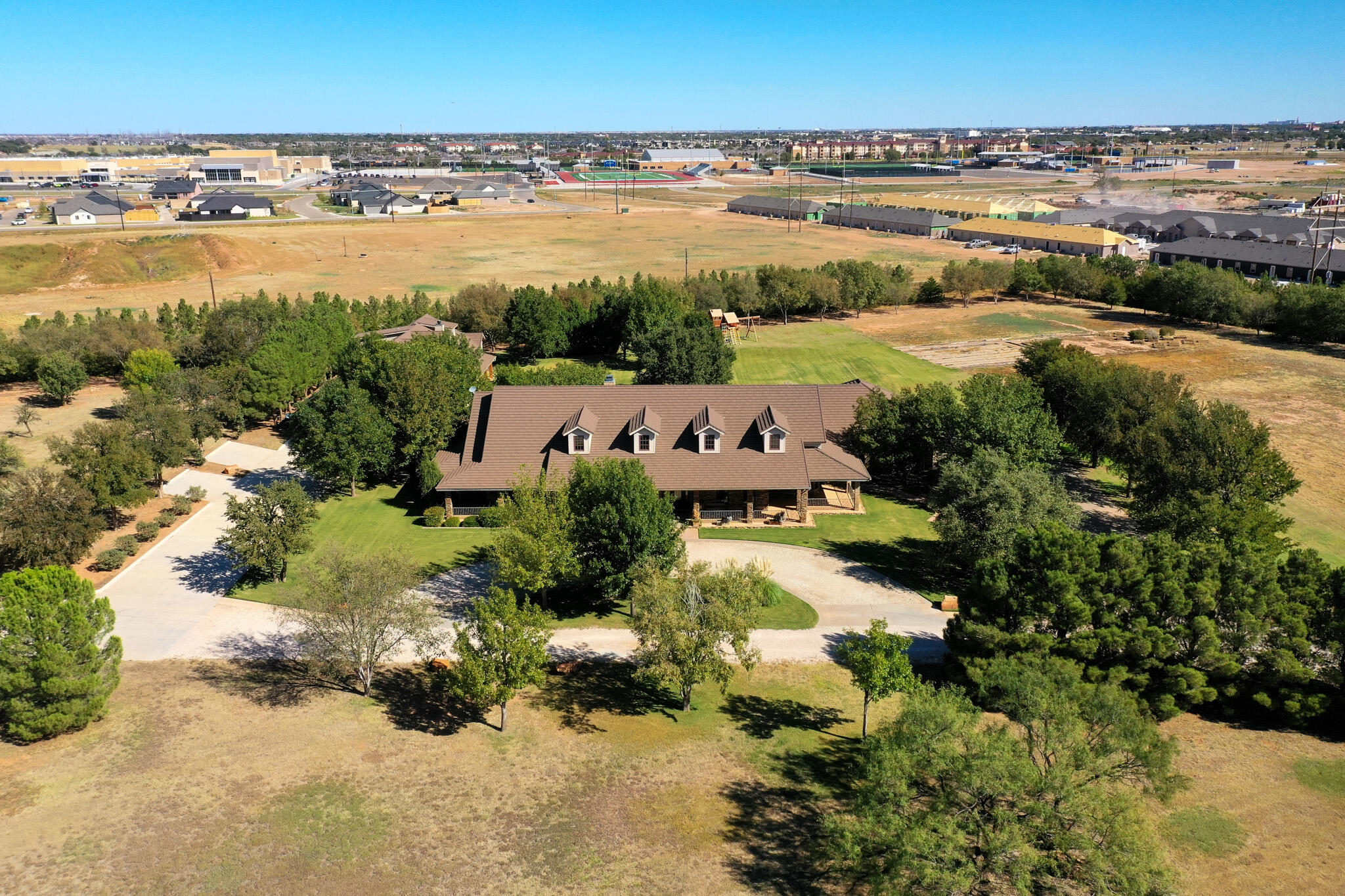 7002 50th Street Lubbock, TX 79407 - Photo 5 of 81 an aerial view of residential building and lake view