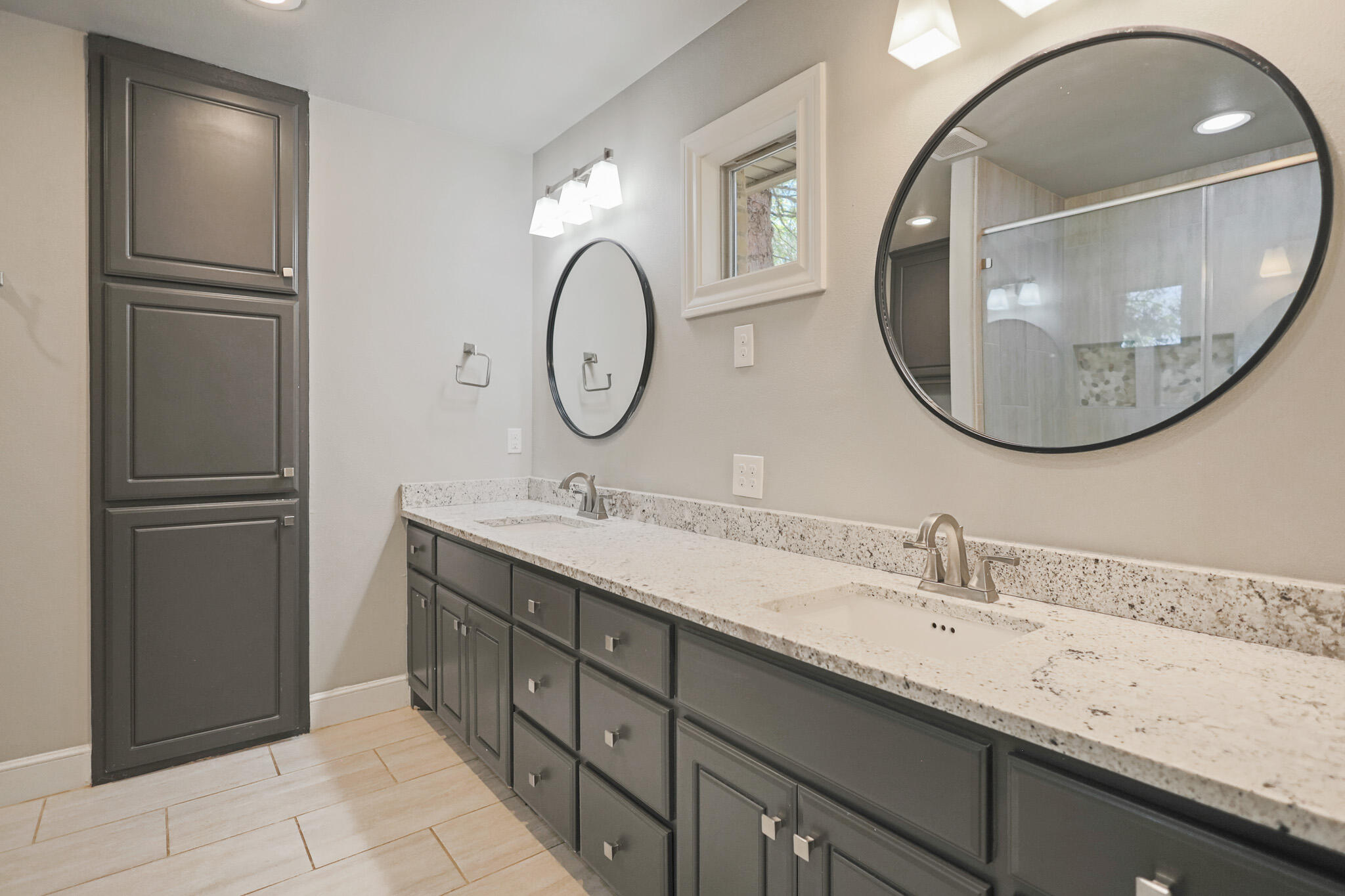 7002 50th Street Lubbock, TX 79407 - Photo 59 of 81 a bathroom with a double vanity sink and a mirror
