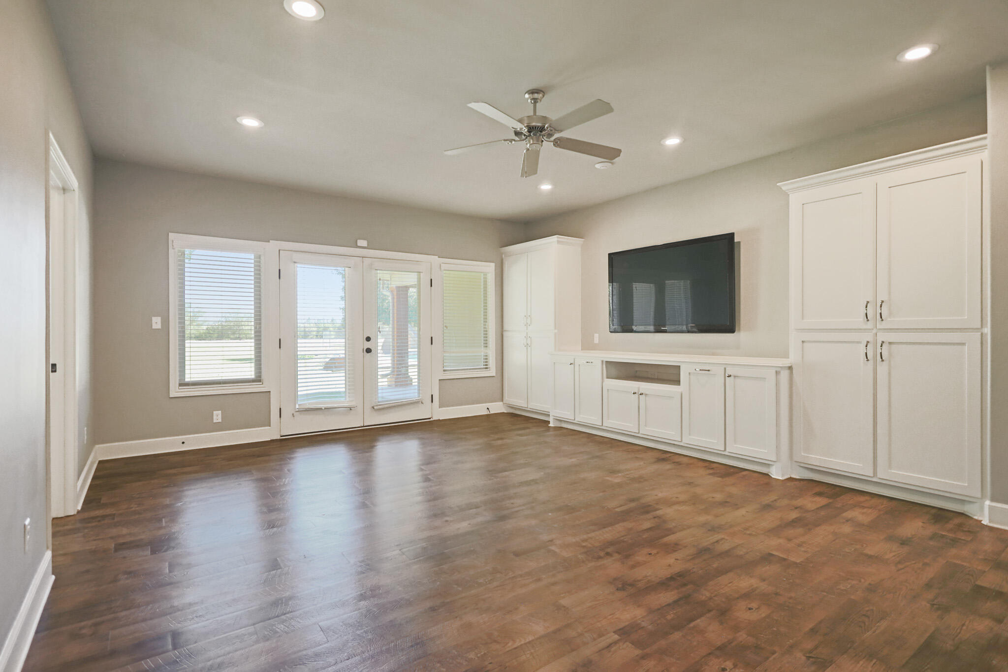 7002 50th Street Lubbock, TX 79407 - Photo 62 of 81 a view of an empty room with a window and wooden floor