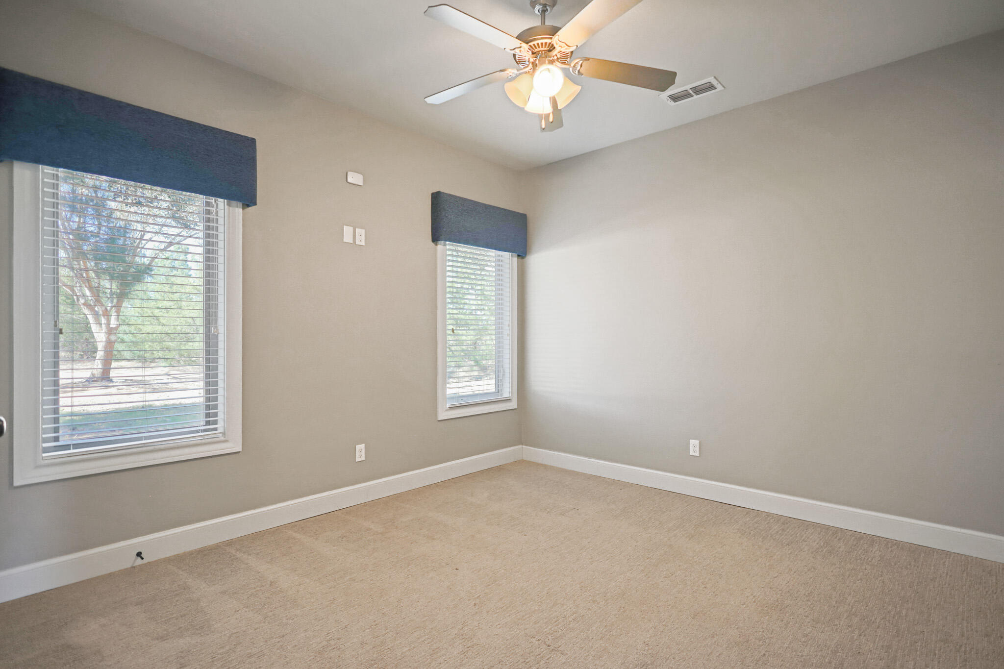 7002 50th Street Lubbock, TX 79407 - Photo 63 of 81 an empty room with a window and a fan