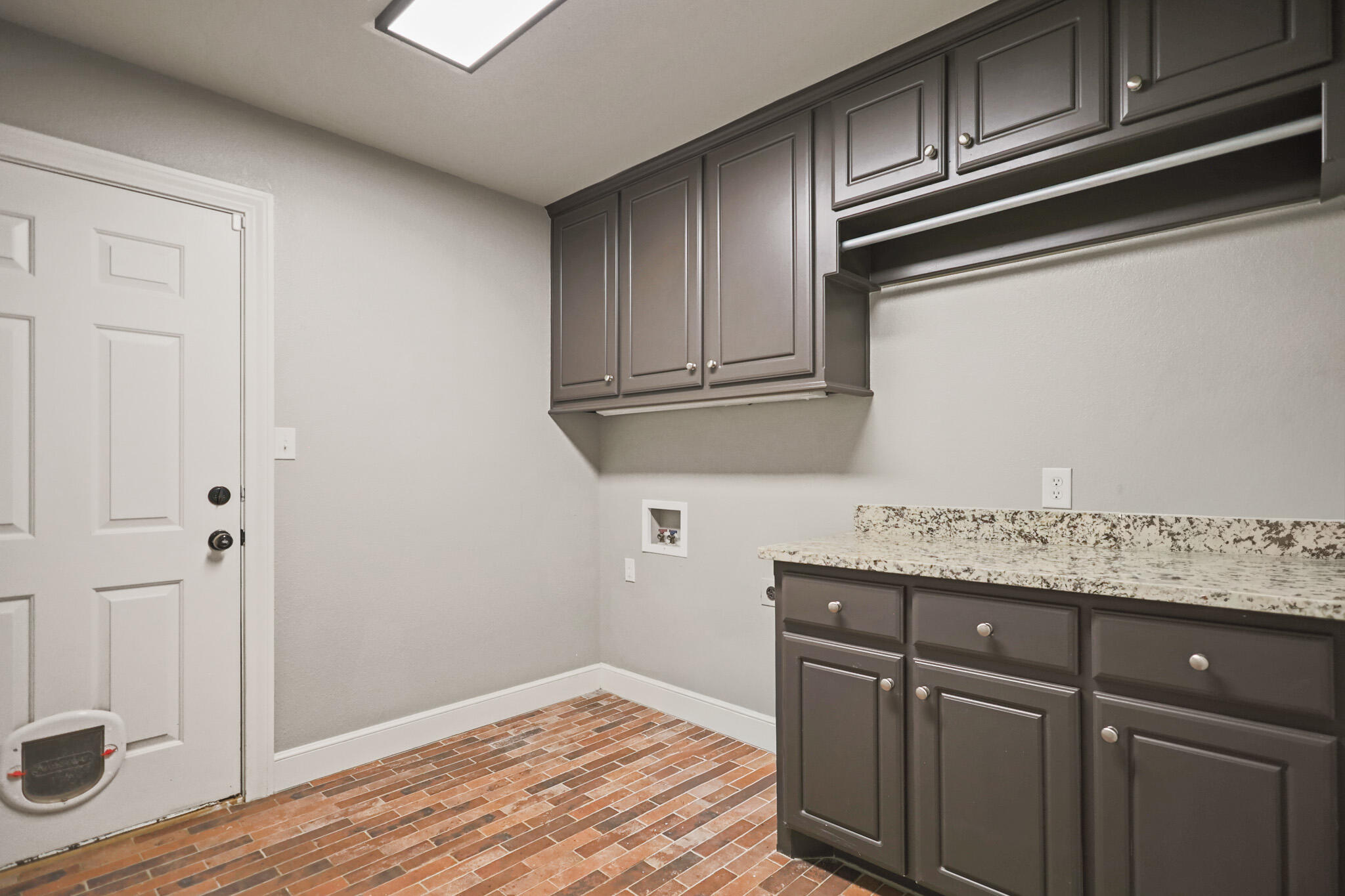 7002 50th Street Lubbock, TX 79407 - Photo 71 of 81 a kitchen with stainless steel appliances granite countertop a sink and cabinets with wooden floor