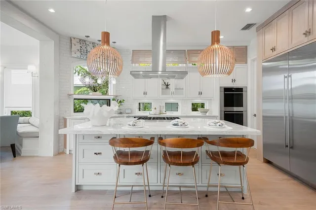a kitchen with cabinets and chairs