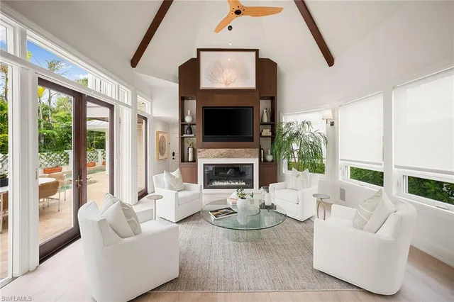 a living room with furniture a fireplace and a flat screen tv
