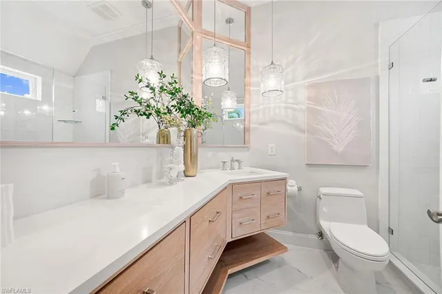 a view of a house with brick walls and potted plants