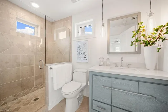 a view of a house with a small yard and wooden fence