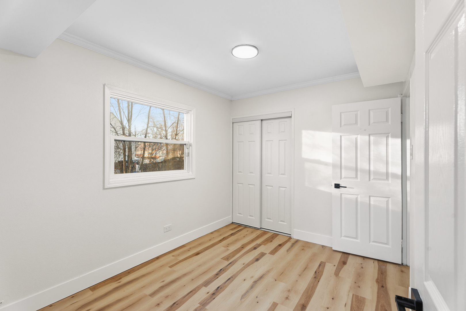 409 Winnemac Street Park Forest, IL 60466 - Photo 12 of 21 a view of an empty room with wooden floor and a window