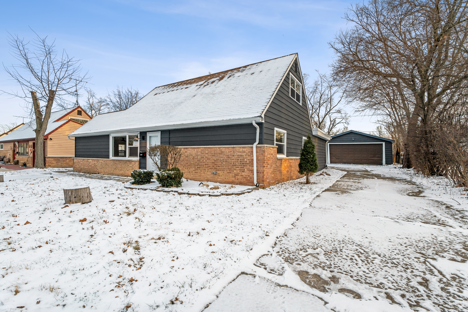 409 Winnemac Street Park Forest, IL 60466 - Photo 2 of 21 a front view of a house with a yard and garage