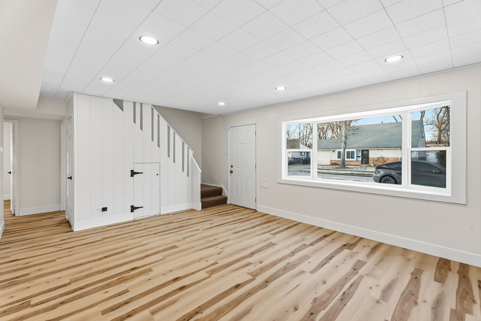 409 Winnemac Street Park Forest, IL 60466 - Photo 4 of 21 a view of an empty room with a window and wooden floor