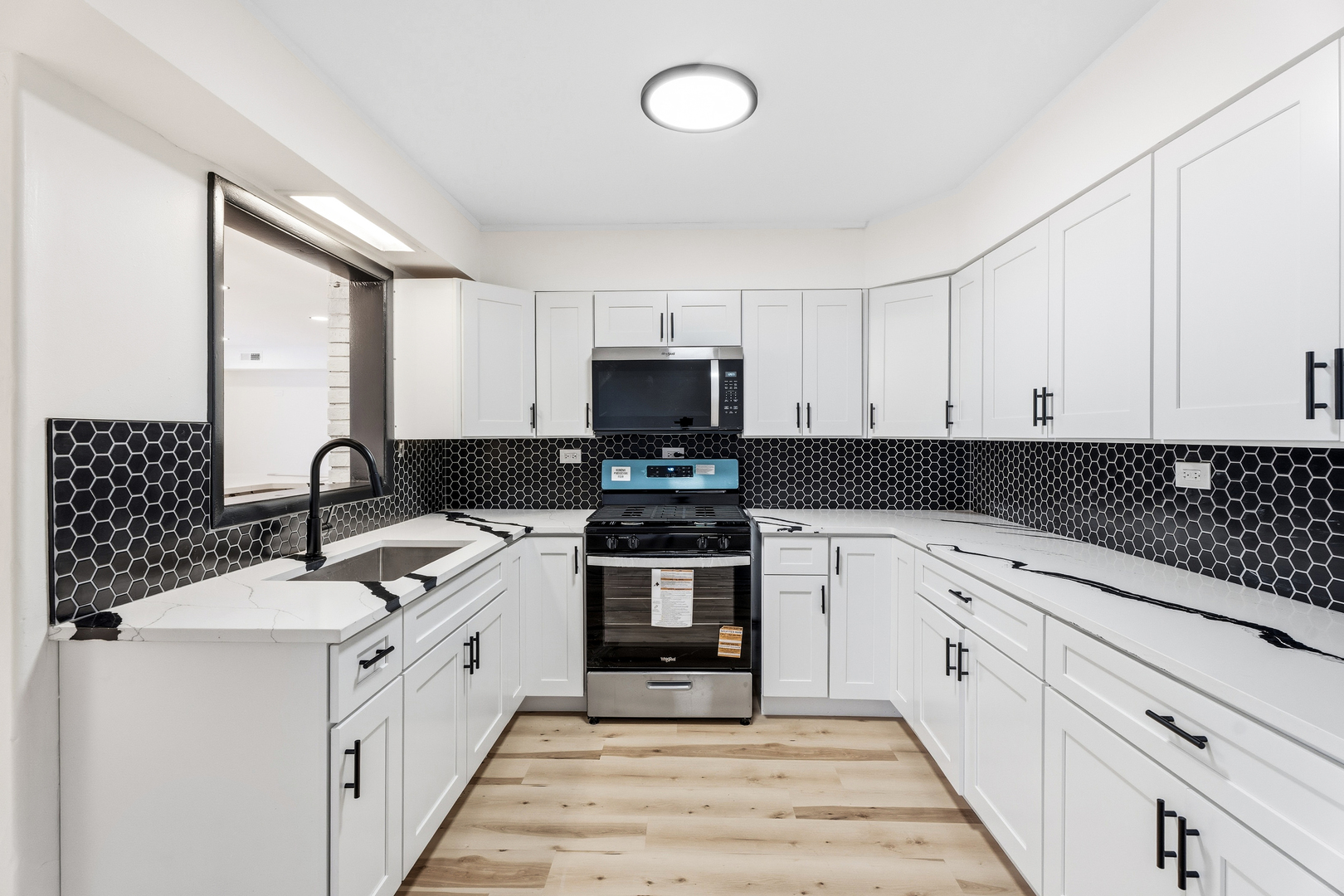 409 Winnemac Street Park Forest, IL 60466 - Photo 7 of 21 a kitchen with a sink stove and microwave
