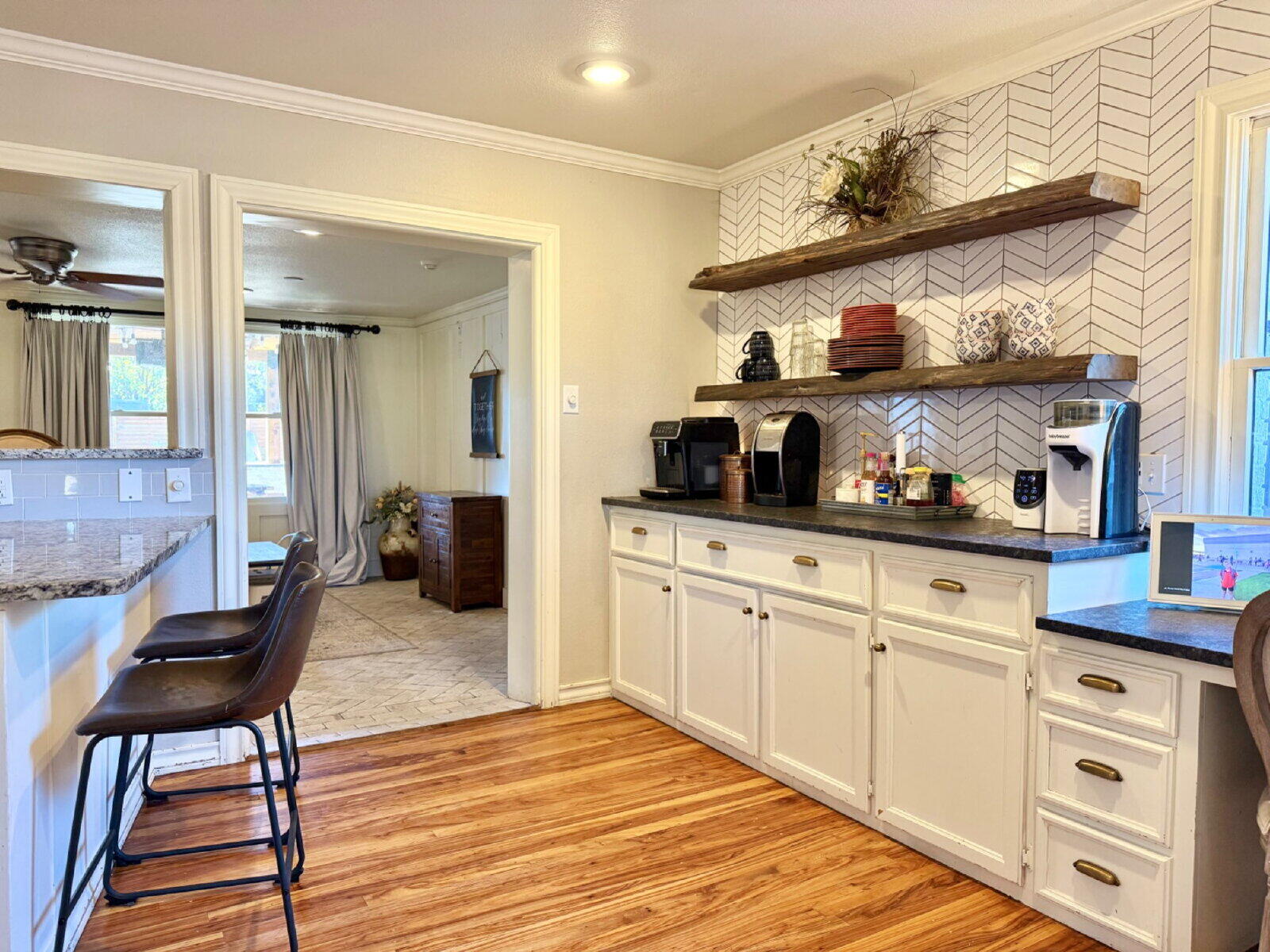 3001 32nd Street Lubbock, TX 79410 - Photo 12 of 35 a kitchen with cabinets and wooden floor