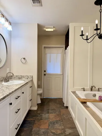 a bathroom with a granite countertop sink mirror and a