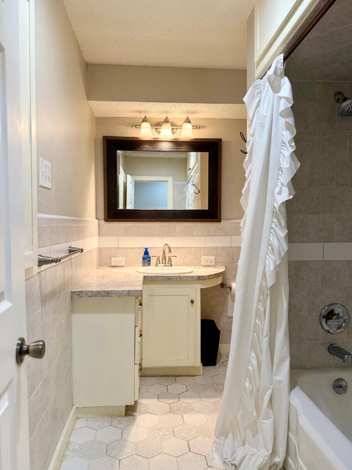 3001 32nd Street Lubbock, TX 79410 - Photo 28 of 35 a bathroom with a sink and mirror