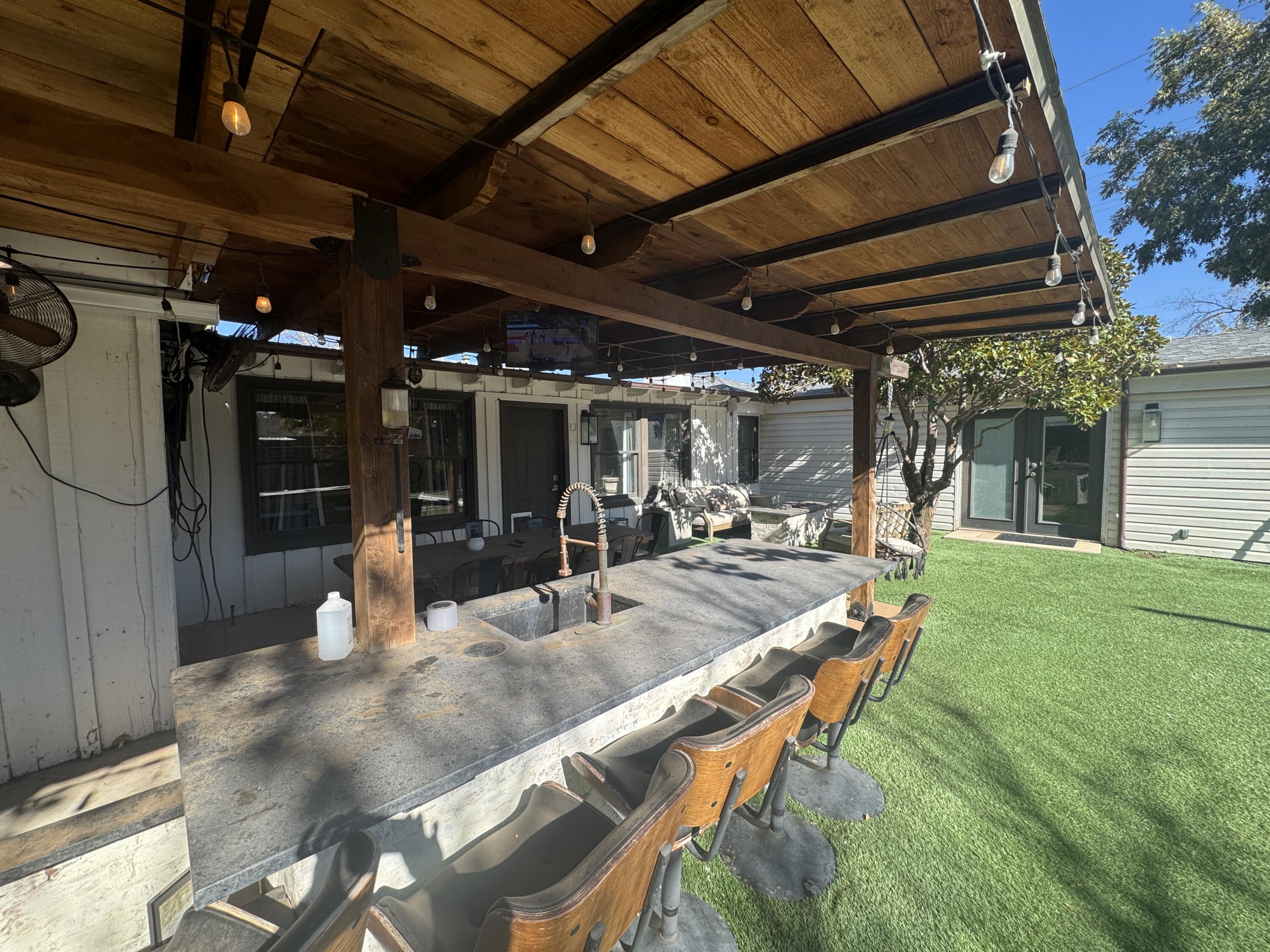 3001 32nd Street Lubbock, TX 79410 - Photo 32 of 35 a view of a backyard with seating space and swimming pool