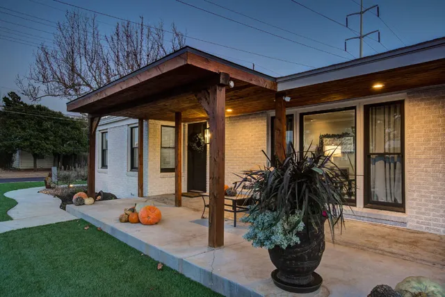 a front view of a house with porch and garden