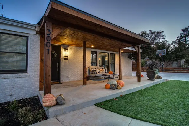 a group of people sitting in front of a house