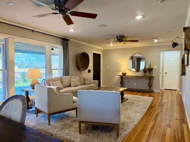 a living room with furniture and a wooden floor