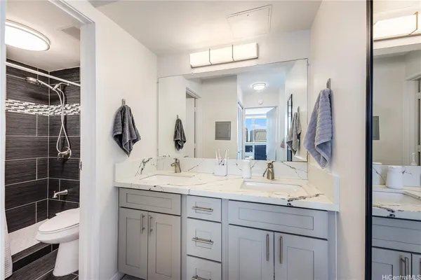 a bathroom with a double vanity sink and a mirror