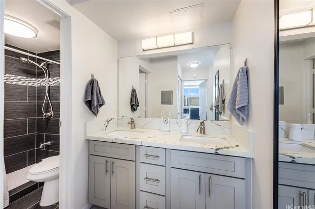 a bathroom with a double vanity sink and a mirror