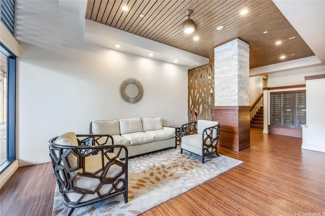 a living room with furniture and wooden floor
