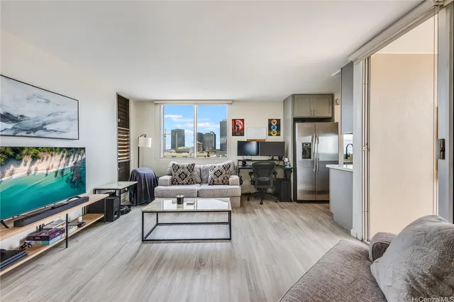 a living room with furniture a flat screen tv and a floor to ceiling window