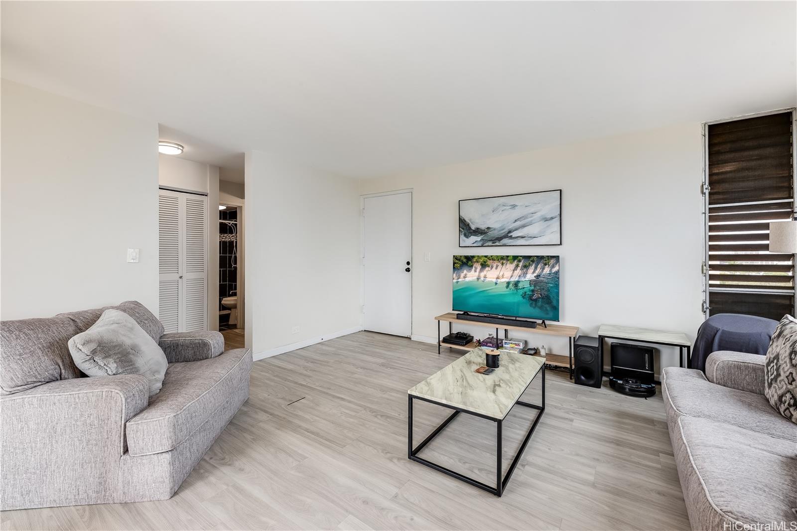 785 Kinau Street, Unit PH4 Honolulu, HI 96813 - Photo 2 of 23 a living room with furniture and a flat screen tv